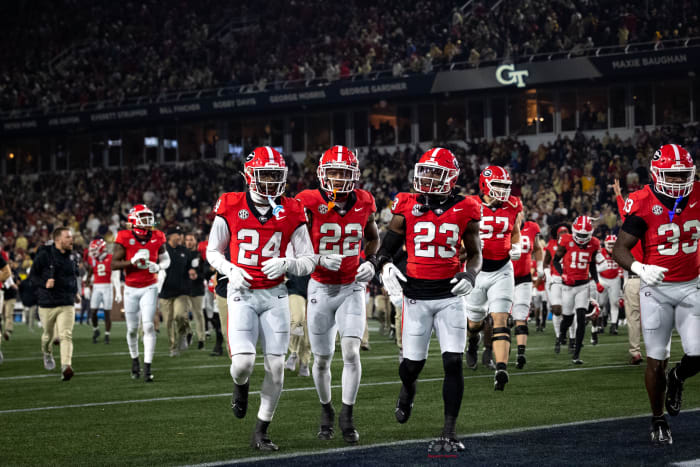 Georgia Bulldogs secondary trio of (#24) Malaki Starks, (#22) Javon Bullard, and (#23) Tykee Smith trotting off the field for halftime against Georgia Tech on Nov. 25, 2023. (Brooks Austin / Dawgs Daily).